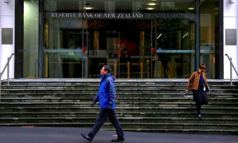 NZ central bank holds rates, tones down hawkish stance
